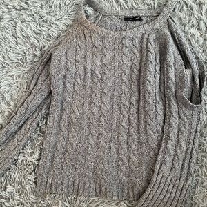 Woman’s cold-shoulder sweater
